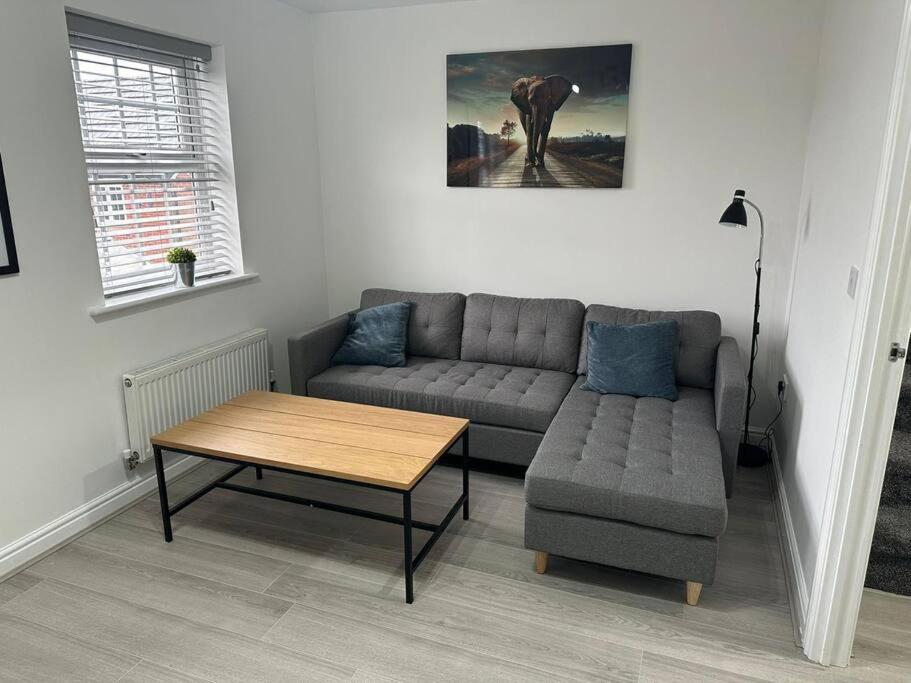 a living room with a couch and a coffee table at Lancers Close House in Leyland