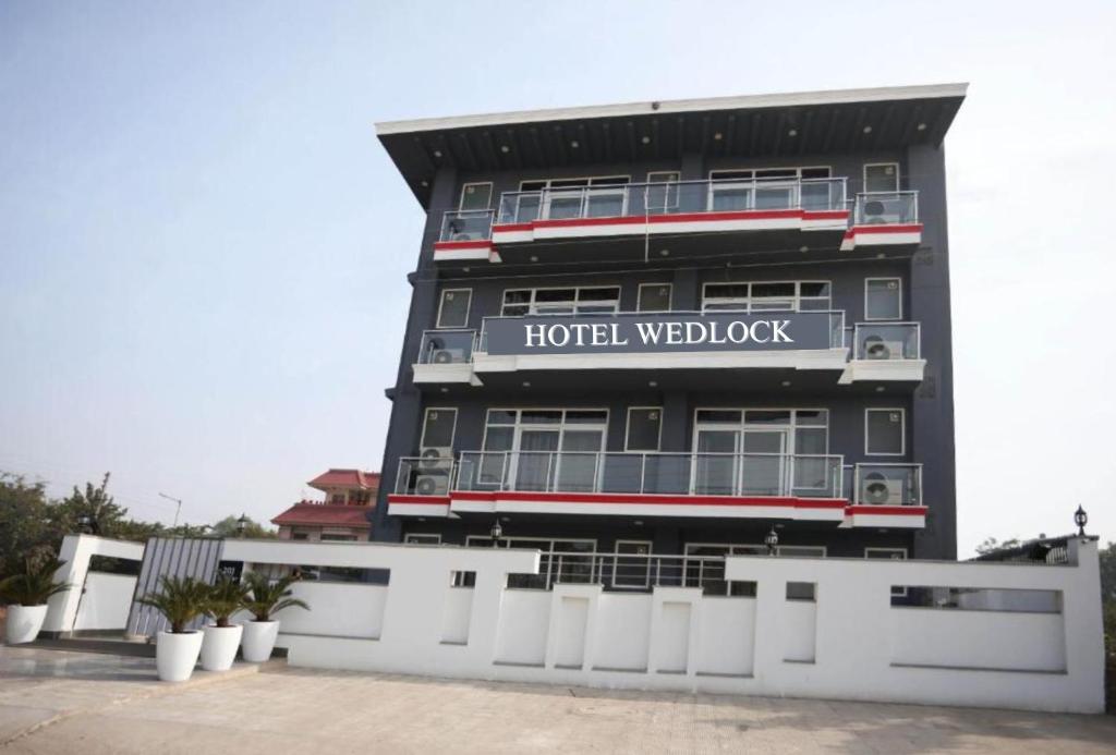 una señal de bienvenida del hotel en el lateral de un edificio en Hotel Wedlock sector 47 en Gurgaon