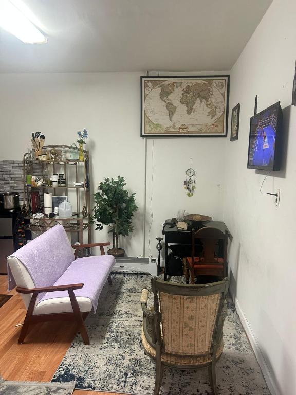 a living room with a couch and a map on the wall at Charming Studio Flat Near Center City in Philadelphia