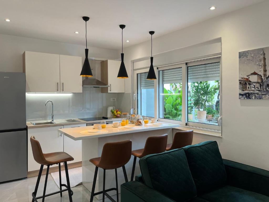 a kitchen and living room with a counter and chairs at Luxury Apartment Lu in Split