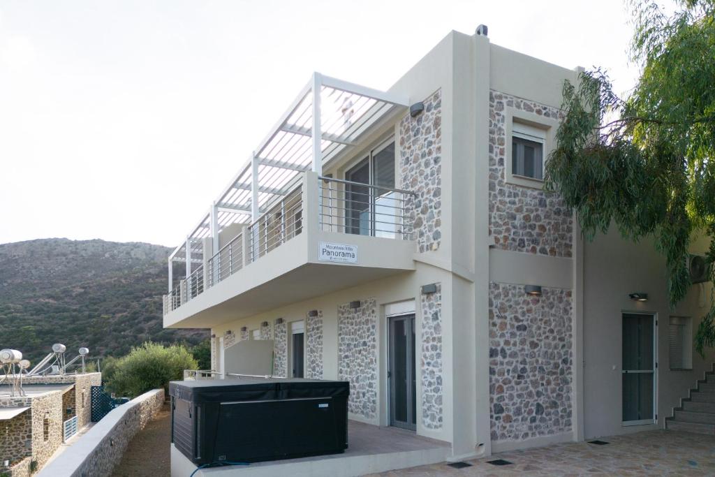 a building with a balcony on the side of it at Mountain Villa Panorama in Stavrokhórion