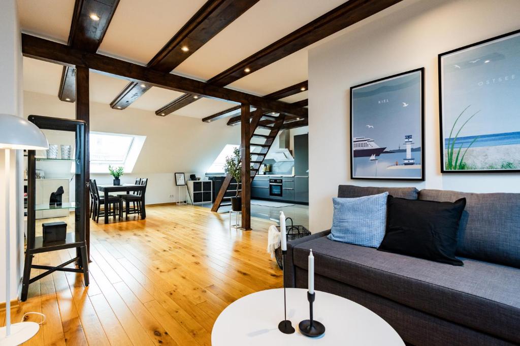 ein Wohnzimmer mit einem Sofa und einem Tisch in der Unterkunft Exklusive Apartments in Kieler City in Kiel