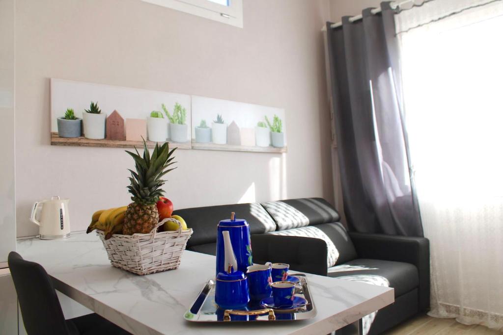 a living room with a table and a couch at Casa Franca in Maracalagonis