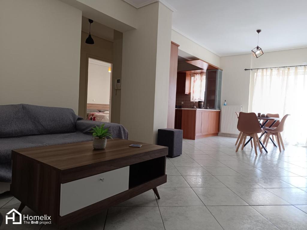 a living room with a couch and a table at Spacious 2bedroom apartment in Chalkida