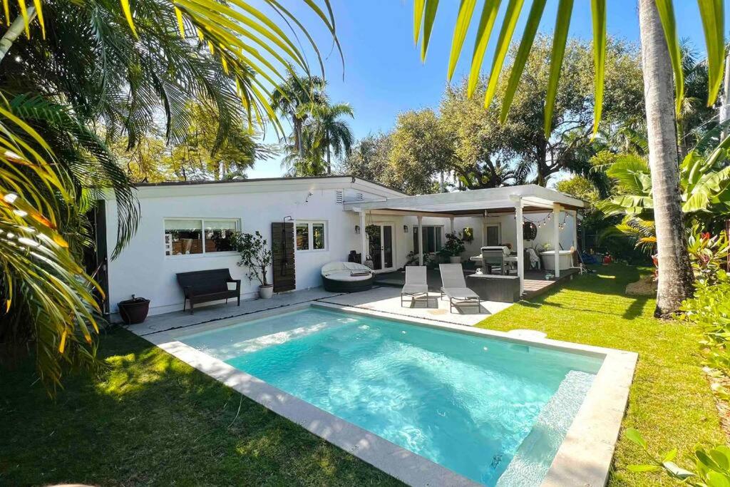 a swimming pool in front of a house at Pool! Best location! Steps to the water! Kid friendly! in Miami