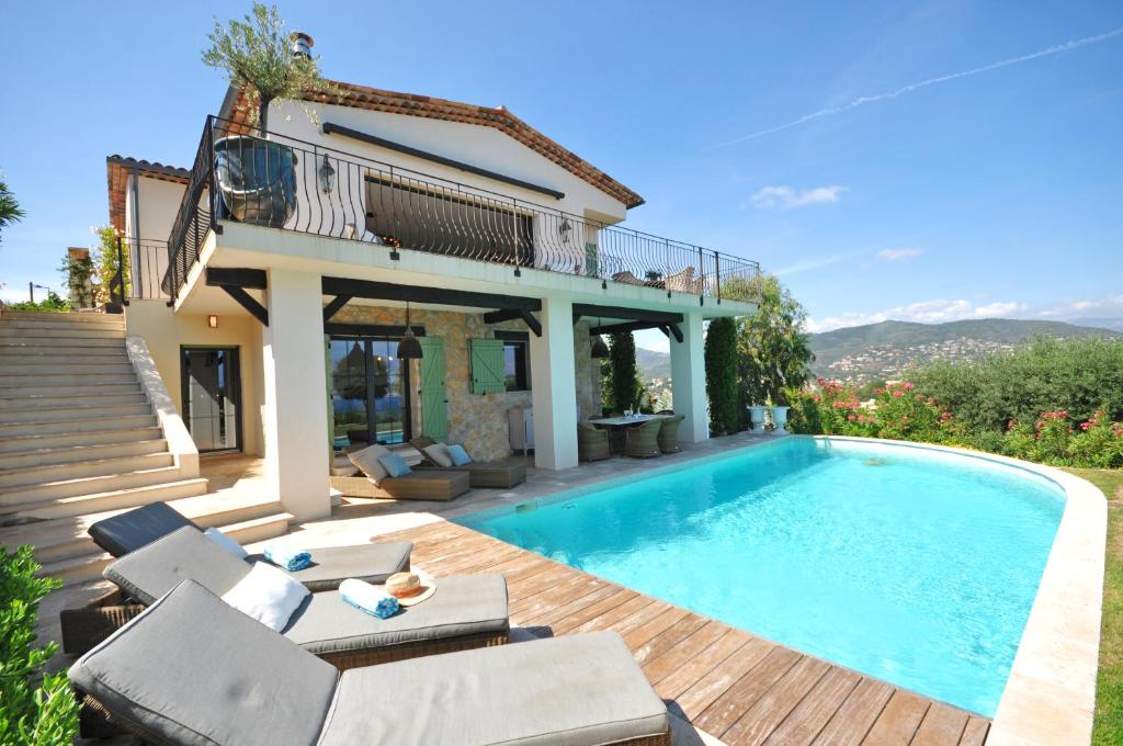 a villa with a swimming pool and a house at Riviera Living in Mandelieu-la-Napoule
