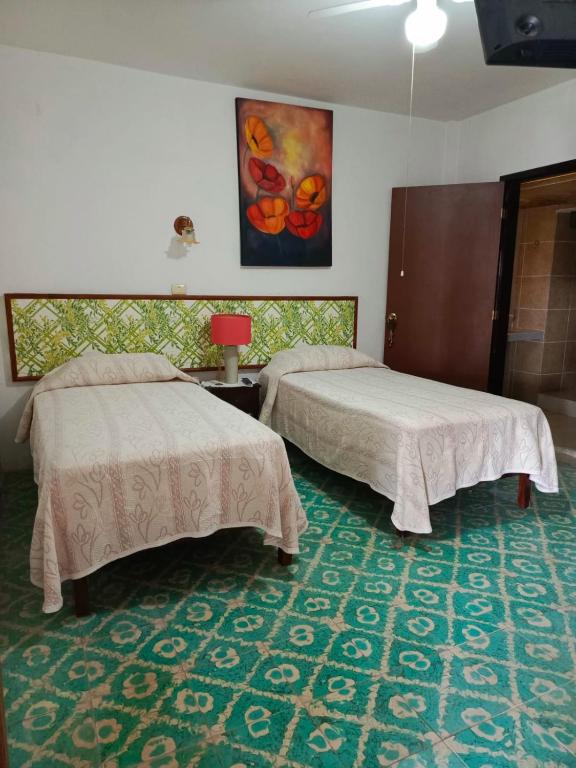 Postel nebo postele na pokoji v ubytování Posada Familiar Papantla