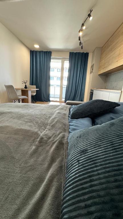 a bedroom with a large bed with blue curtains at AR ALBELLI HOUSE II in Košice