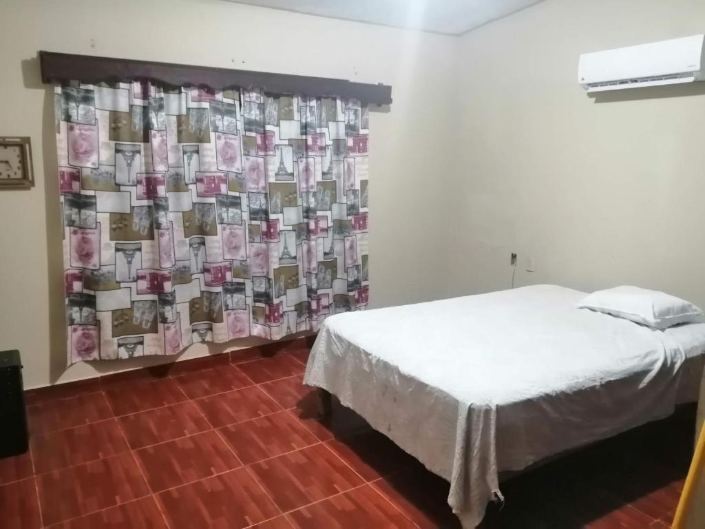 um quarto com uma cama e uma cortina com dinheiro em White House em Ciudad Valles