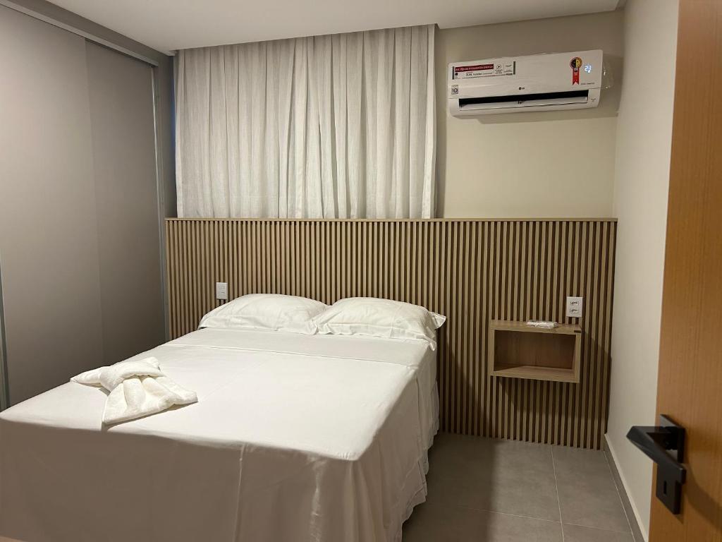 ein Schlafzimmer mit einem großen Bett mit weißer Bettwäsche in der Unterkunft Loft Solaris Apart Hotel - Suíte - Apt. N.105 in João Câmara