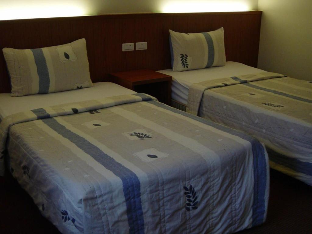 Postel nebo postele na pokoji v ubytování Good Ground Hotel Tainan