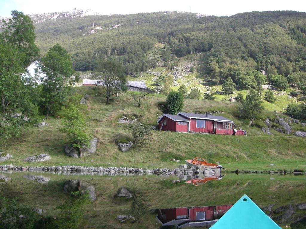 a red house on the side of a hill at Hytte ved Preikestolen in Forsand