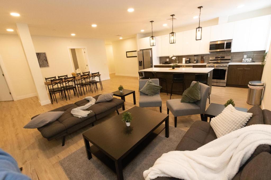 een woonkamer met een bank en stoelen en een keuken bij Spacious 3-BR Luxury Suite near New York City in Union City