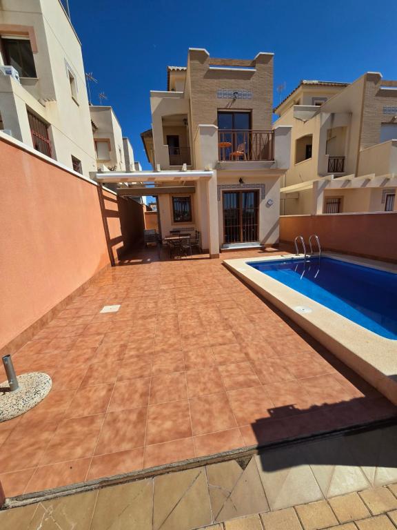 a view of a house with a swimming pool at Duplex 6 Mar de Plata in Puerto de Mazarrón