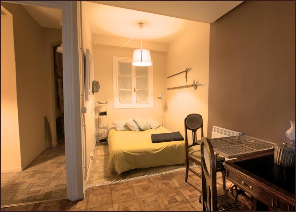 a bedroom with a bed and a table in a room at Tolosa un mundo de sensaciones in Tolosa