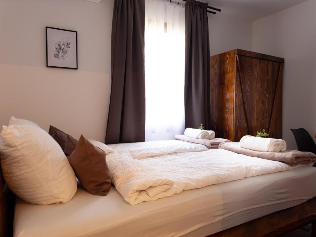 two beds in a bedroom with towels on them at Golubina 2 - Studio Apartman in Golubac