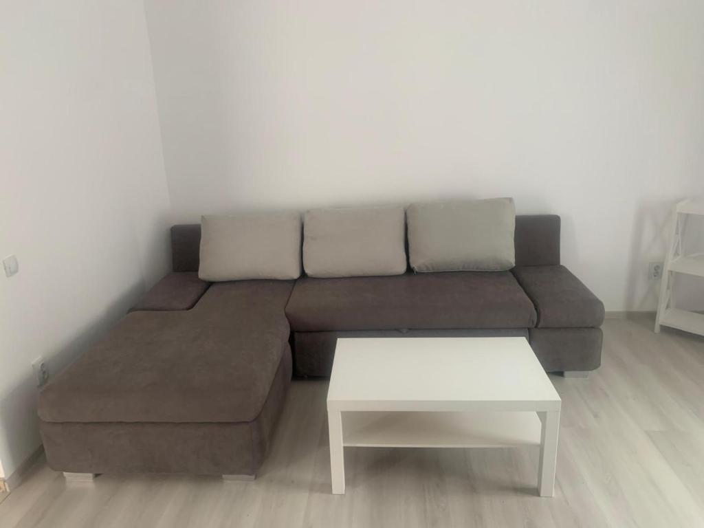 a living room with a couch and a table at Aparthouse in Lugoj