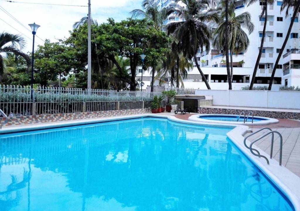a swimming pool with blue water in a building at Apto 2Habs 2baños Hermosa vista in Cartagena de Indias