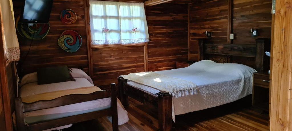 Postel nebo postele na pokoji v ubytování Congos Hostal y Camping