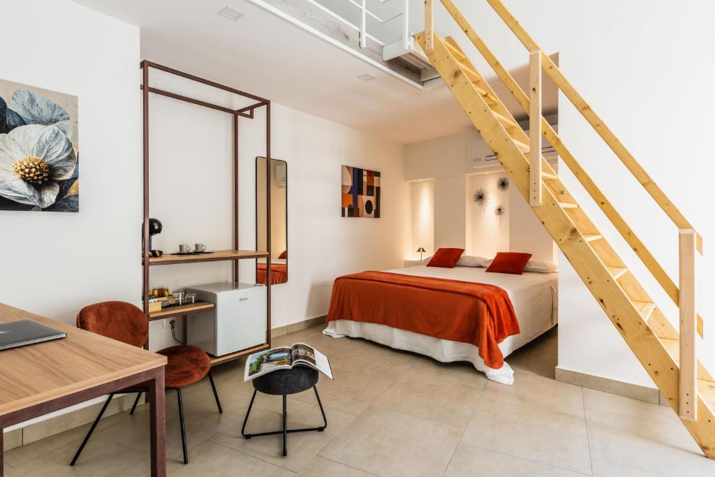 a bedroom with a bed and a staircase at Case Varanni Etna Experience in Viagrande