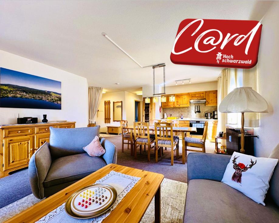 a living room with two couches and a table at Ferienwohnung Lotti + Hochschwarzwald Card in Titisee-Neustadt