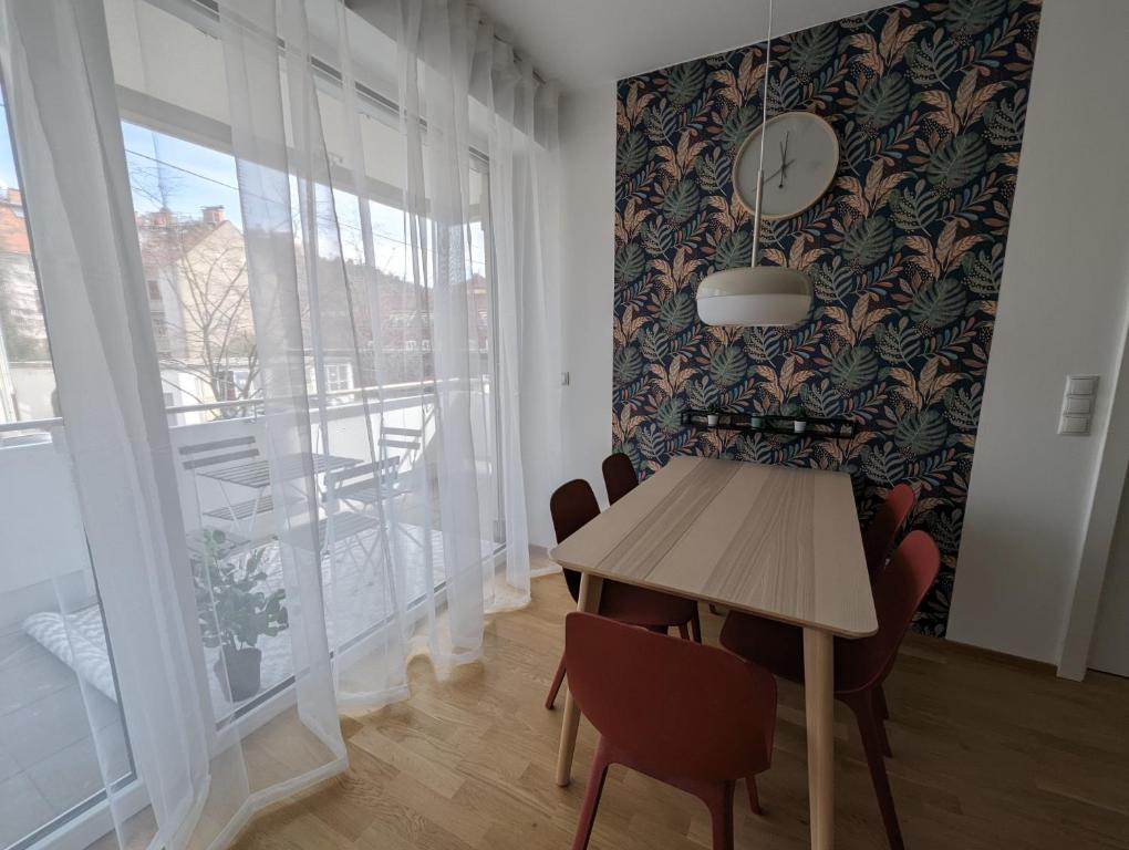 a dining room with a table and a large window at Lend City Apartment Family keyless entry in Graz