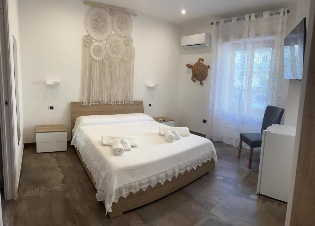 ein Schlafzimmer mit einem Bett mit Handtüchern darauf in der Unterkunft B&B Hakuna Matata in Alghero