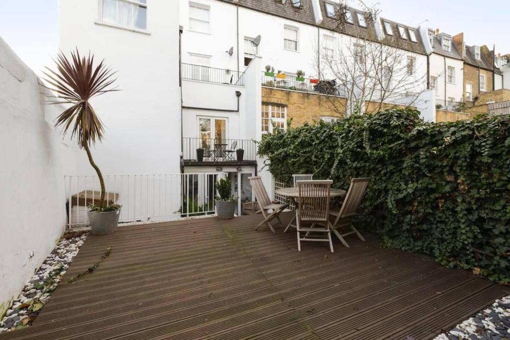 a patio with a table and chairs on a balcony at Remarkable 2-Bed House in London in London