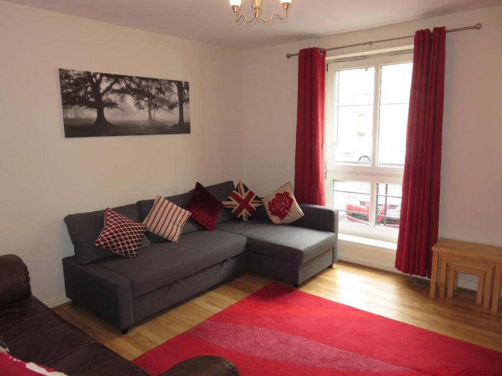 a living room with a couch and a window at Waverley Park Apartment in Edinburgh