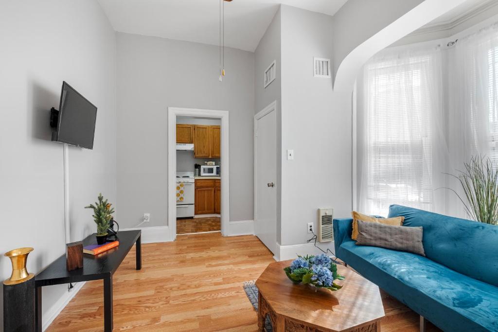 a living room with a blue couch and a table at Cozy, Charming 1-bdrm - University City in Philadelphia