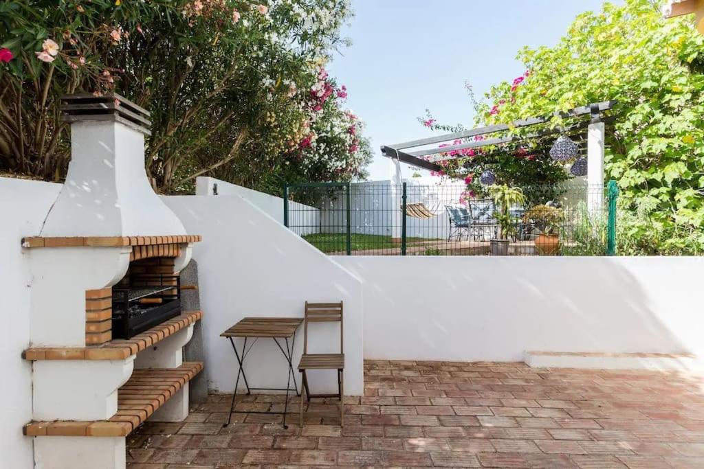 a white wall with a table and a stair case at 3 bedroom villa, 10min walk to shops, bars & beach in Luz