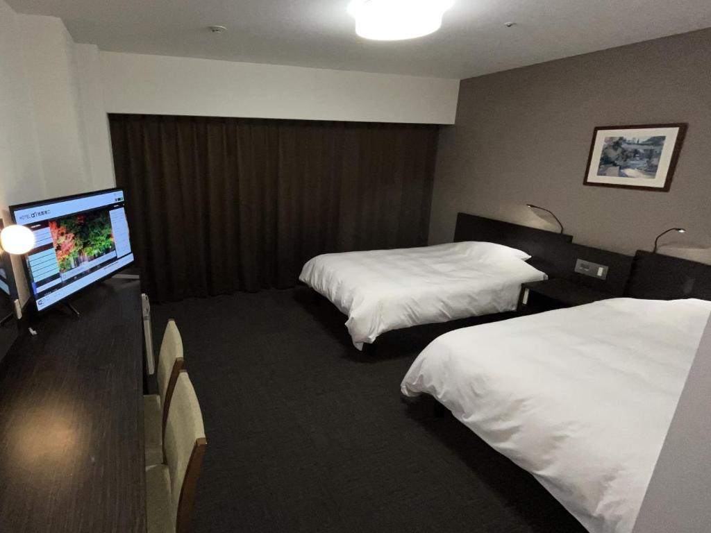 Postel nebo postele na pokoji v ubytování Hotel Alpha-One Himeji Minamiguchi