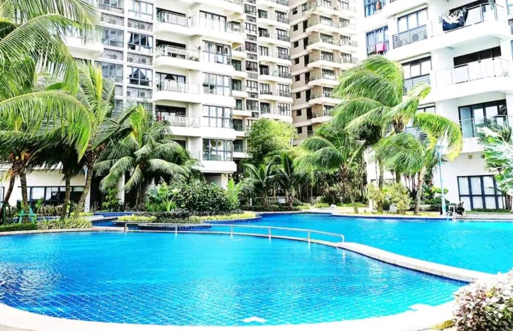 a large swimming pool in front of a large apartment building at seaview beach 4-13pax/CIQ 5mins/ johor bahru ambersite in Johor Bahru