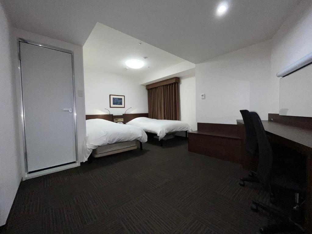 Postel nebo postele na pokoji v ubytování Hotel Alpha-One Kurashiki