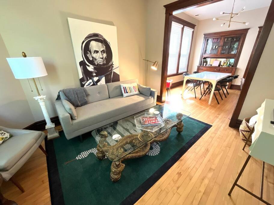 a living room with a couch and a table at Irving Park updated vintage top unit 2-flat in Chicago