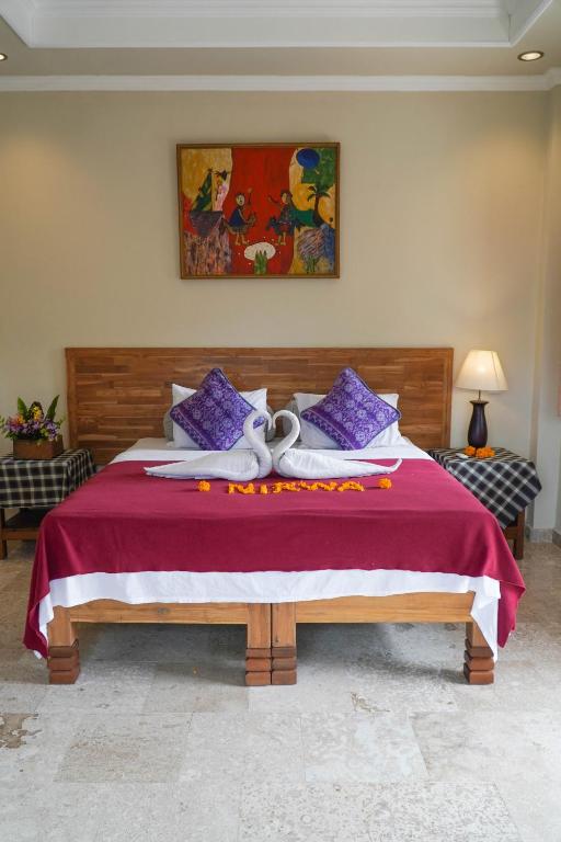 Postel nebo postele na pokoji v ubytování Nirwa 1 Ubud Guesthouse