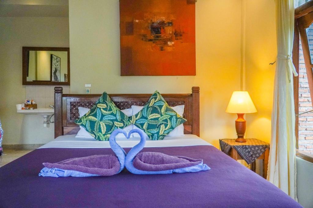 Postel nebo postele na pokoji v ubytování Nirwa 1 Ubud Guesthouse