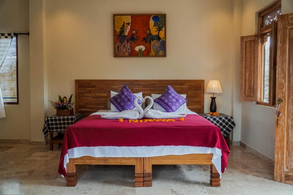 Postel nebo postele na pokoji v ubytování Nirwa 1 Ubud Guesthouse