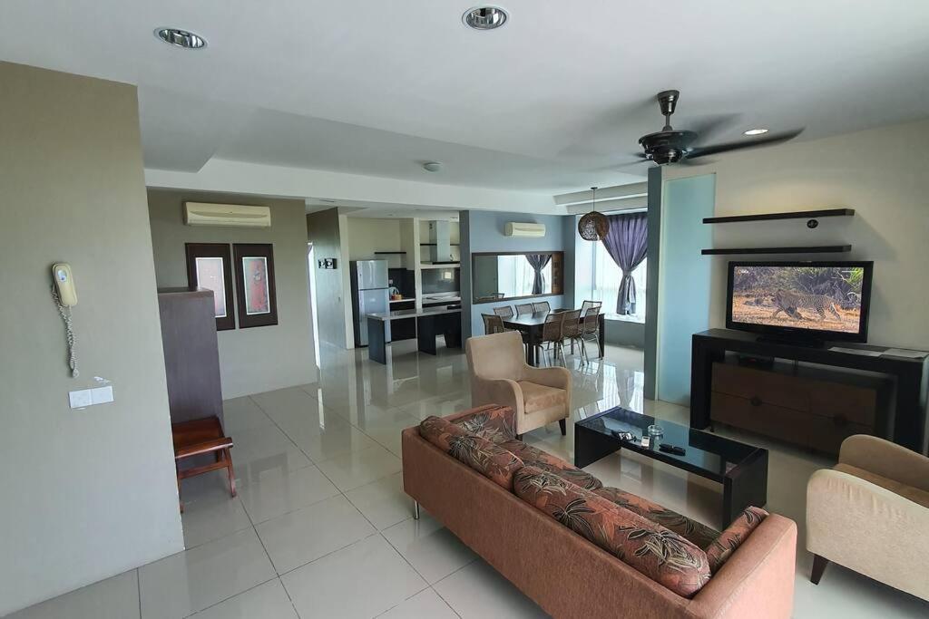 a living room with a couch and a flat screen tv at Sky Residence -3 Bedrooms Condo at Cinta Sayang, Sungai Petani in Sungai Petani