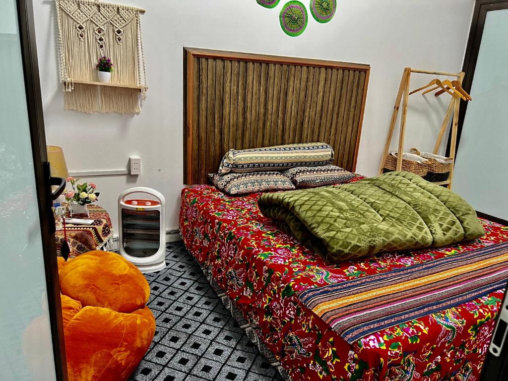 a bedroom with a bed with a colorful blanket at AKa HomeStay in Yên Minh