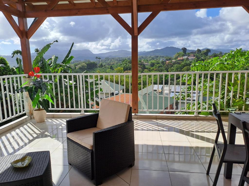 a balcony with a chair and a view of the mountains at BELLA in Gros-Morne