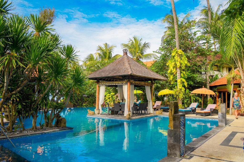 a pool at a resort with a gazebo at Bayside Bungalows in Candidasa