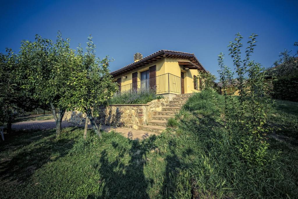 a house on a hill with stairs leading up to it at Agriturismo I Roseti in Montepulciano