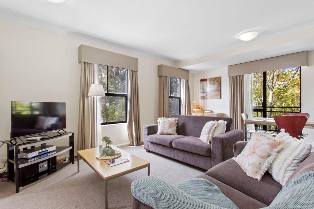 a living room with a couch and a tv at 2BDR 1BTH - James Street Magic in Perth