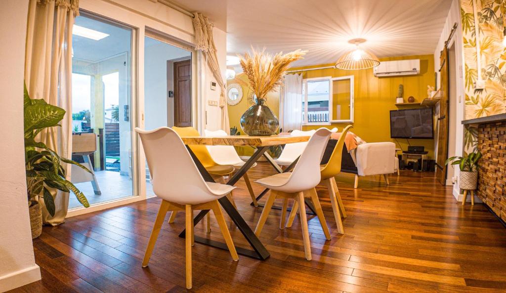 a dining room with a table and chairs at Villa Osao Panahy in Le Patelin
