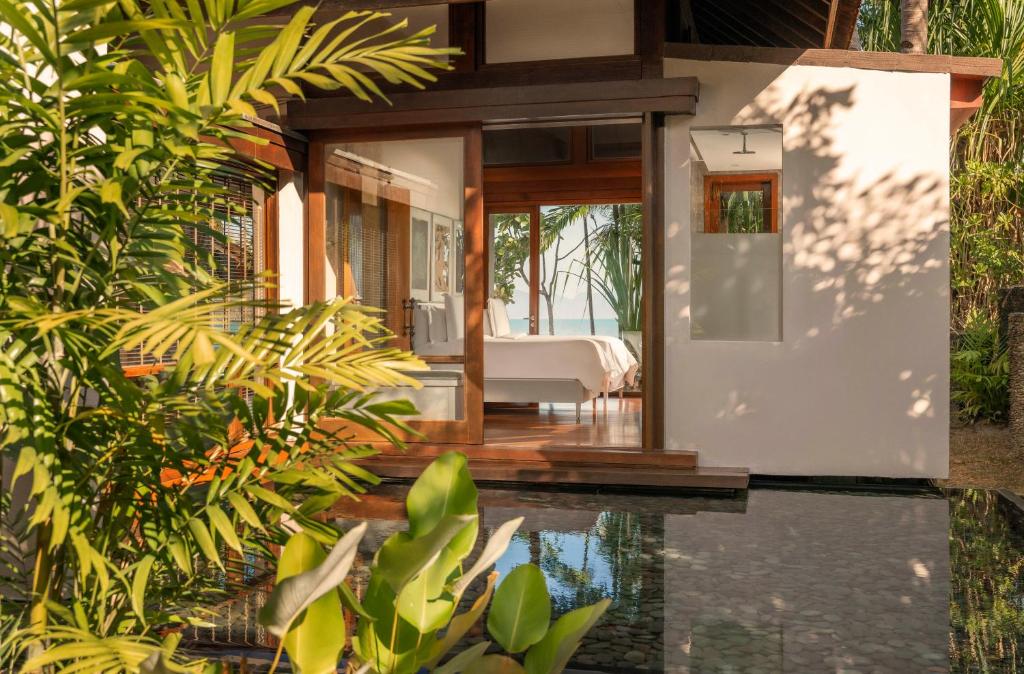 a house with a pool in front of it at Four Seasons Resort Langkawi in Tanjung Rhu