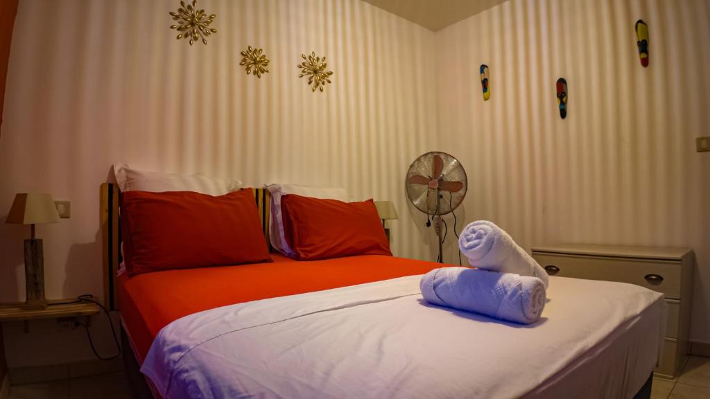 a bedroom with a bed with an animal on it at Villa Osao Panahy in Le Patelin