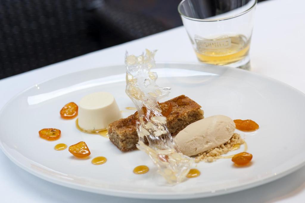 a white plate with food on a table at Bushmills Inn Hotel & Restaurant in Bushmills