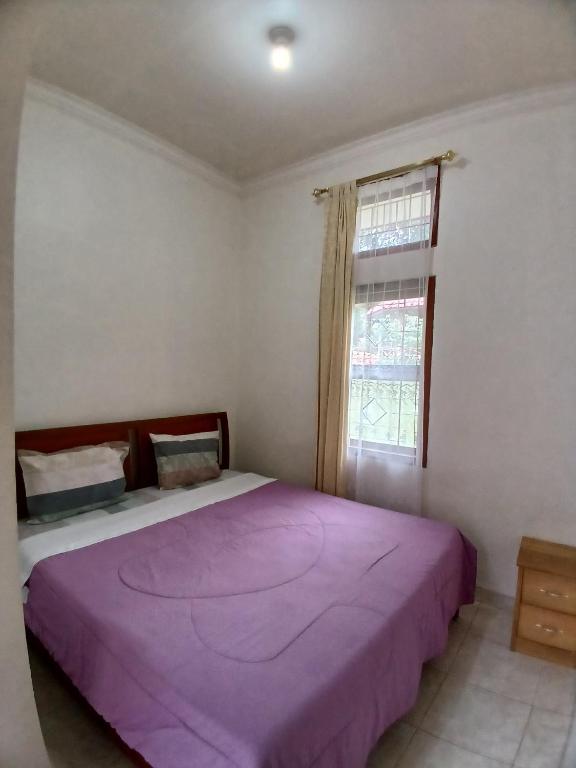 Postel nebo postele na pokoji v ubytování Hotel MBC Ruteng