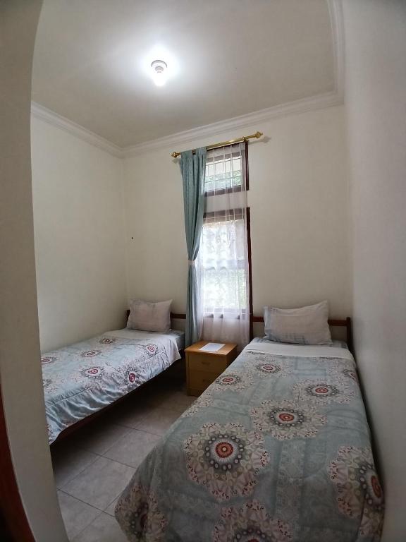 Postel nebo postele na pokoji v ubytování Hotel MBC Ruteng